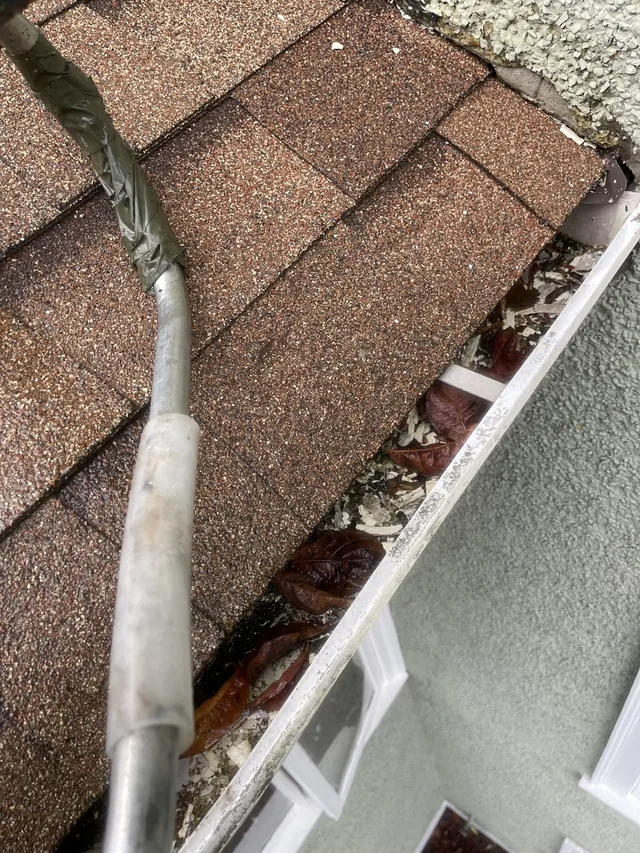Before cleaning: a clearer gutter at the roof corner.